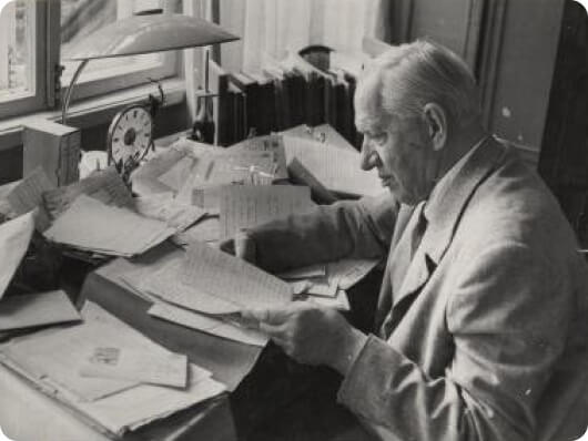 К. И. Чуковский cидит в кабинете за письменным столом с бумагами в Переделкино. 1963